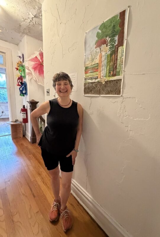 Fran Beallor with her painting in the Climate Imaginarium on Governor's Island, 2026